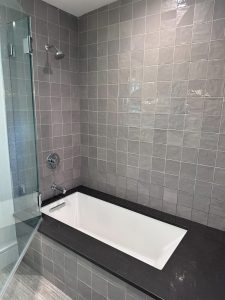 gray square shower tile installation